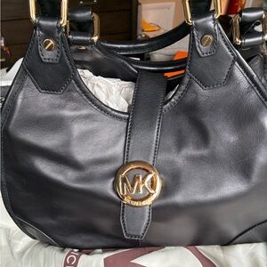 Michael Kors Black Shoulder Bag with Gold Accents.  Medium size